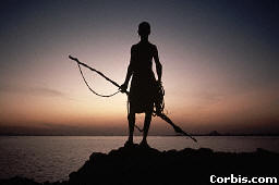 Ba-Chwezi Hunter, watching the Sunset off of the Grand Lake, near the Rwenzori